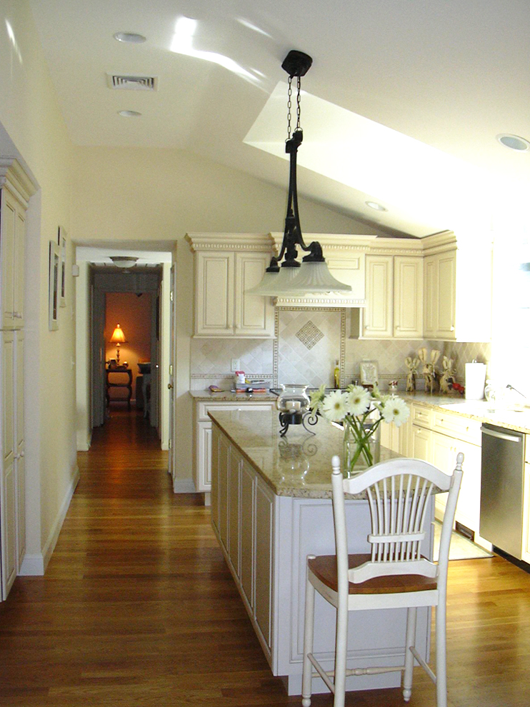 white kitchen with skylight and island